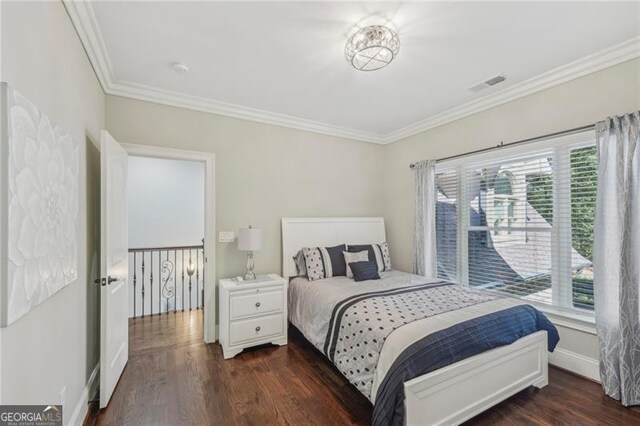 bedroom featuring crown molding and dark hardwood / wood-style flooring