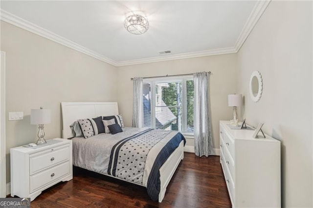 bedroom with baseboards, ornamental molding, and dark wood finished floors