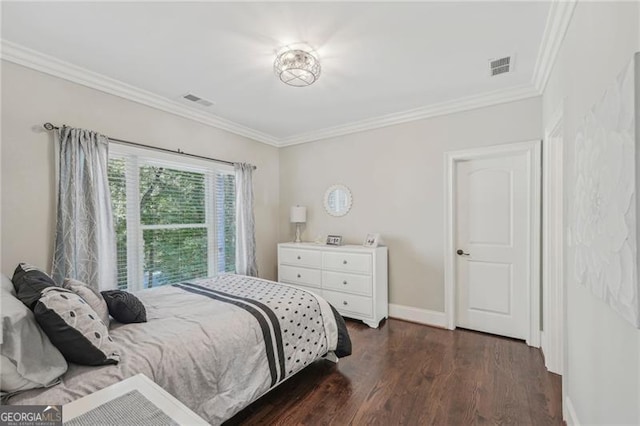 bedroom with ornamental molding, visible vents, dark wood finished floors, and baseboards