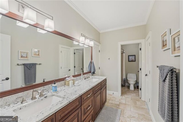 bathroom featuring vanity, ornamental molding, and hardwood / wood-style flooring