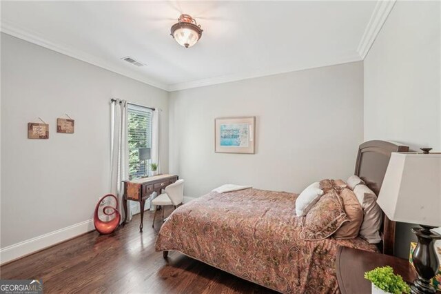 bedroom with ornamental molding, dark hardwood / wood-style floors, and a closet