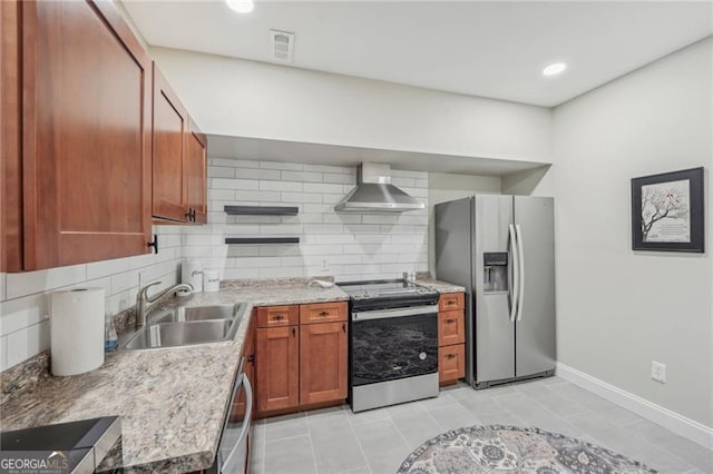 kitchen with wall chimney range hood, backsplash, appliances with stainless steel finishes, light tile patterned flooring, and sink