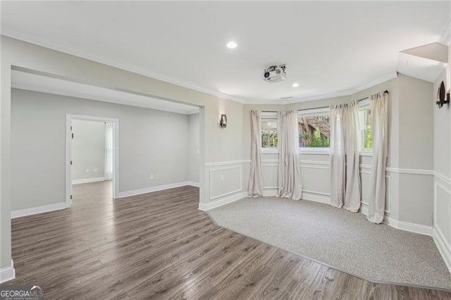 spare room with dark wood-style floors, ornamental molding, recessed lighting, and baseboards