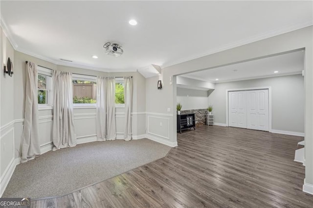 interior space with ornamental molding and dark hardwood / wood-style floors