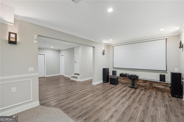 cinema featuring baseboards, a wainscoted wall, wood finished floors, crown molding, and recessed lighting