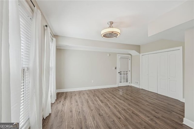 unfurnished bedroom with wood-type flooring and a closet