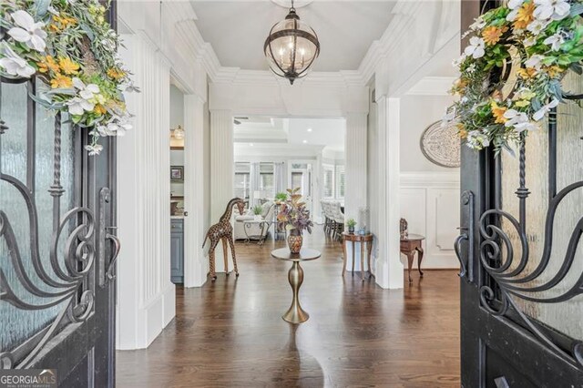 entrance foyer with crown molding, french doors, a chandelier, and dark hardwood / wood-style flooring