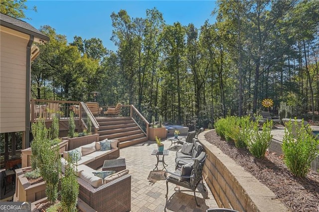 view of patio / terrace featuring stairway and outdoor lounge area