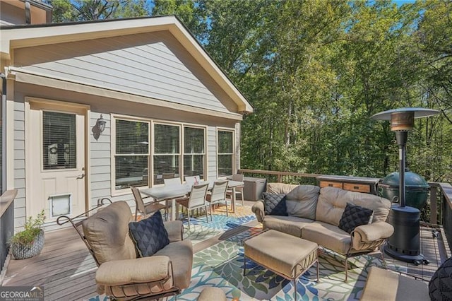 wooden terrace with outdoor dining space and an outdoor living space