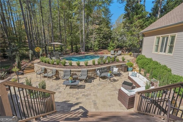 view of patio / terrace featuring an outdoor pool, an outdoor living space, and stairs