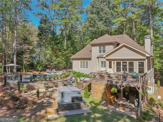 rear view of house with a patio area and a pool side deck