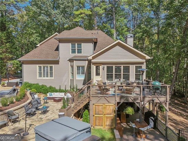 rear view of property with a patio, a chimney, an outdoor hangout area, a wooden deck, and stairs