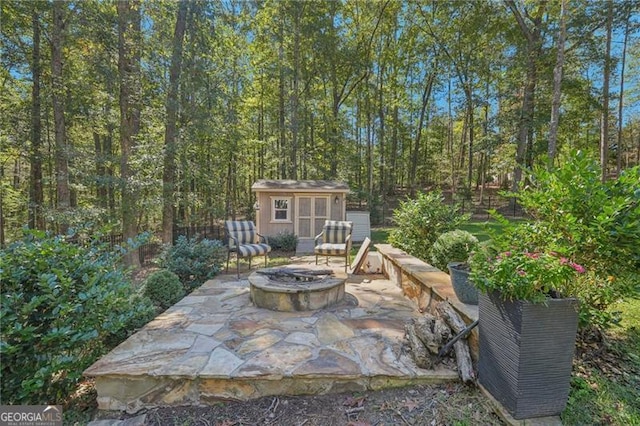 view of patio / terrace with an outbuilding and a fire pit