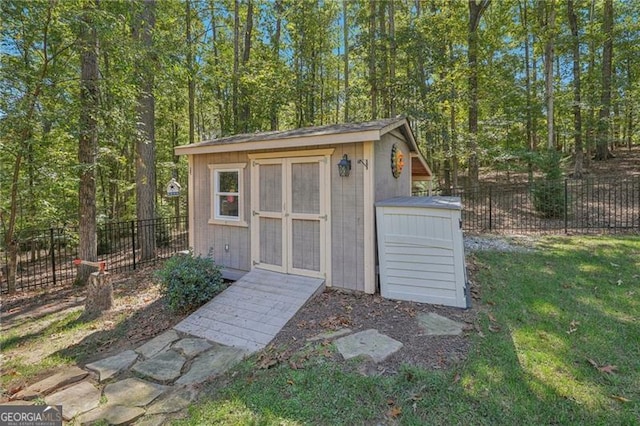 view of shed featuring fence