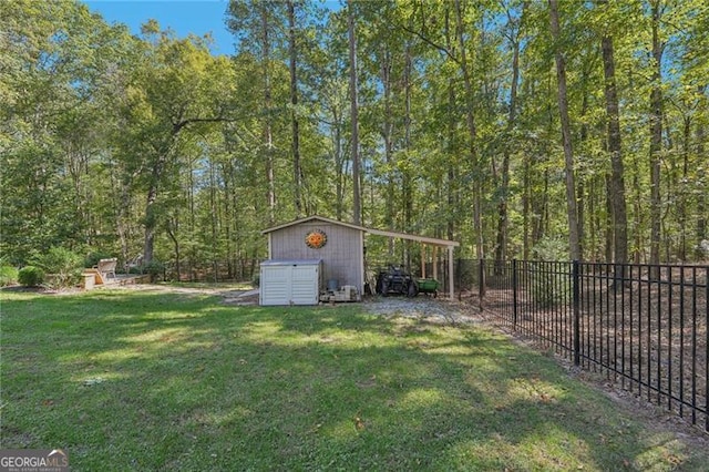 view of yard featuring an outbuilding, fence, and a storage unit