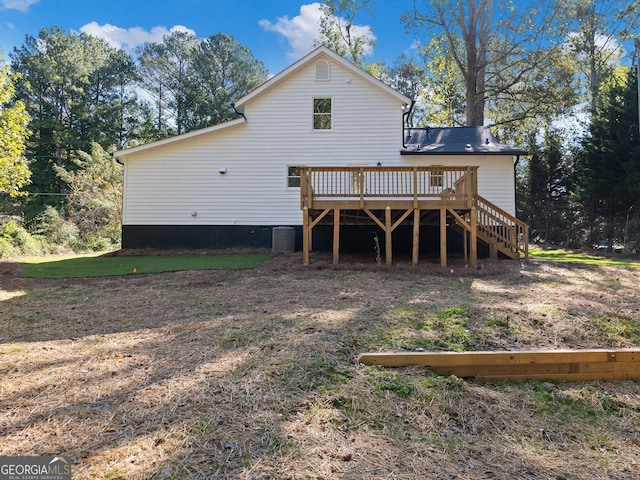 rear view of house with central AC unit and a wooden deck