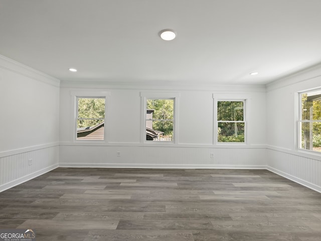 empty room featuring dark hardwood / wood-style flooring and ornamental molding