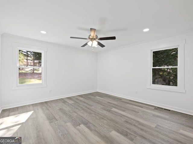 unfurnished room featuring light hardwood / wood-style flooring, ceiling fan, and crown molding