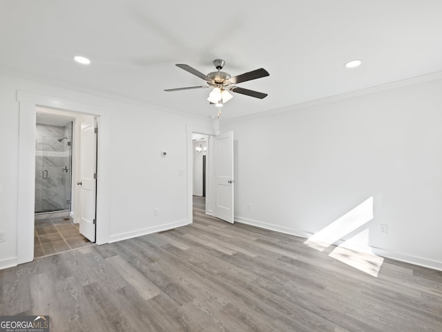 unfurnished bedroom with ensuite bath, ceiling fan, light hardwood / wood-style flooring, and crown molding