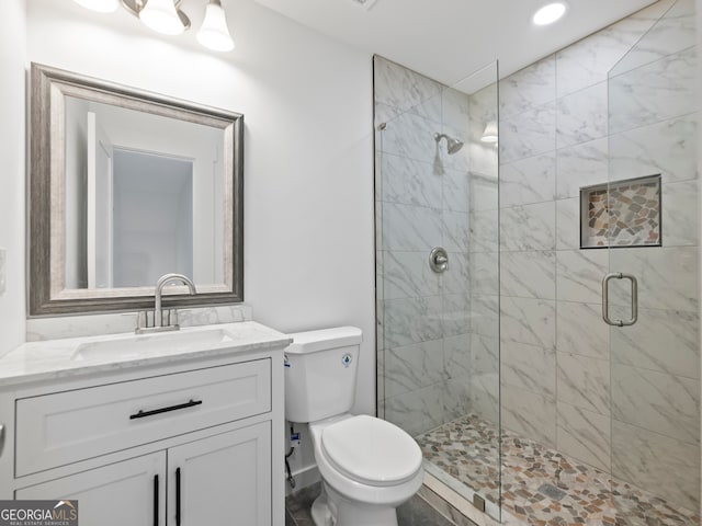 bathroom with vanity, toilet, and an enclosed shower