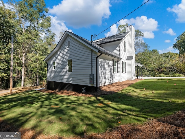 view of property exterior with a yard