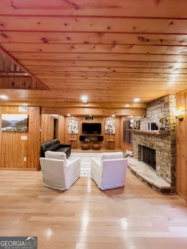 unfurnished living room with wooden ceiling, light wood-type flooring, and wood walls