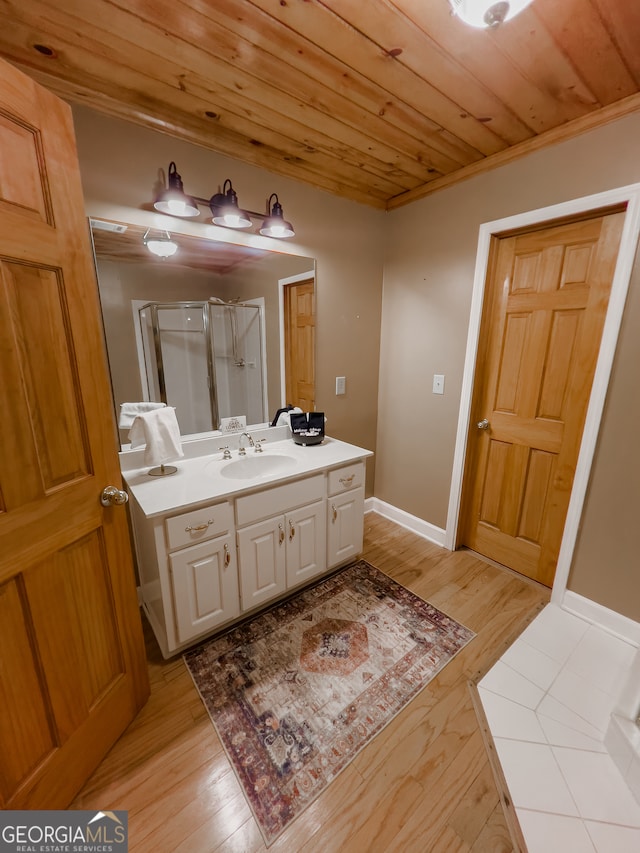 bathroom featuring a shower with door, wood ceiling, hardwood / wood-style flooring, and vanity