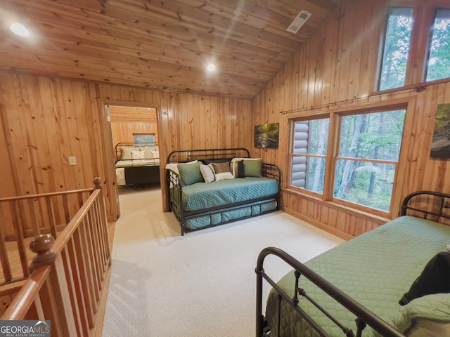 carpeted bedroom with lofted ceiling, wood walls, and wooden ceiling