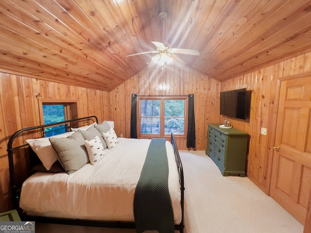 bedroom featuring wood walls, lofted ceiling, ceiling fan, and wooden ceiling