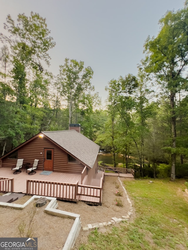 exterior space featuring a deck and a lawn