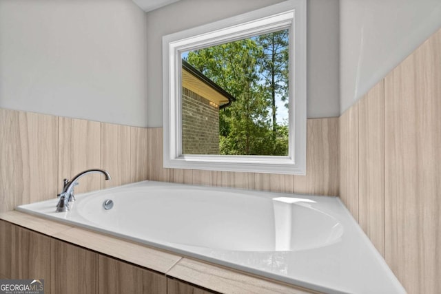 bathroom with tiled tub