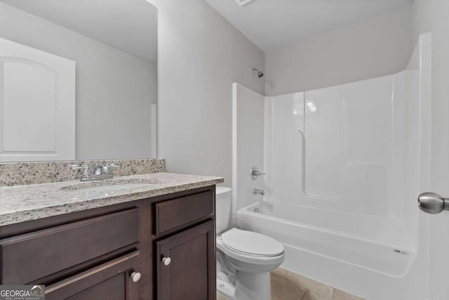 full bathroom featuring vanity, tile patterned floors, toilet, and washtub / shower combination