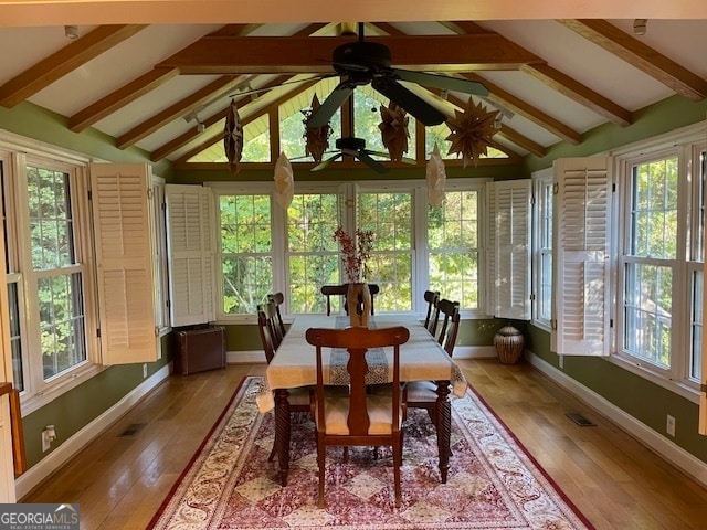 sunroom featuring ceiling fan, lofted ceiling with beams, and a wealth of natural light