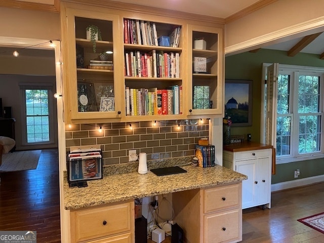 interior space with built in desk, a wealth of natural light, and dark hardwood / wood-style flooring