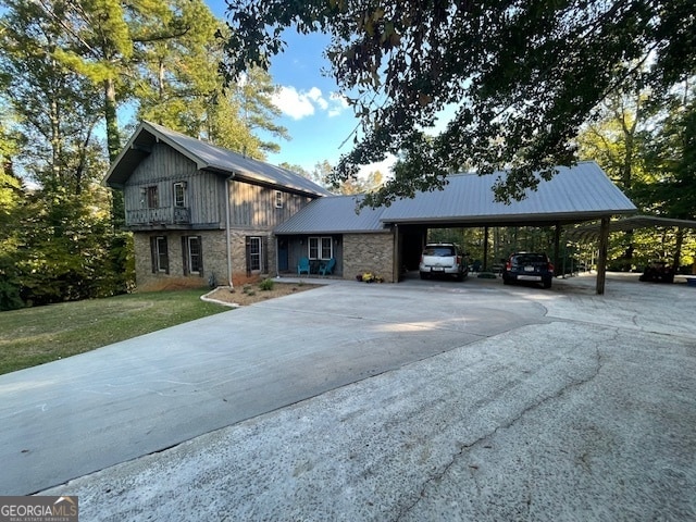 view of front of property with a carport and a front lawn