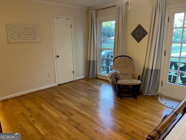 unfurnished room with ornamental molding and light wood-type flooring