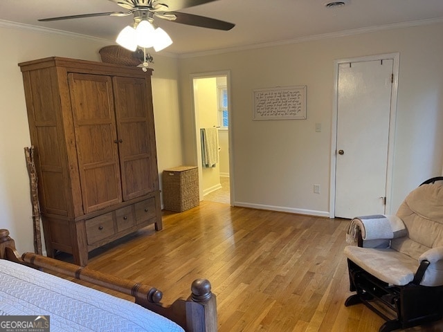 sitting room with light hardwood / wood-style floors, ornamental molding, and ceiling fan