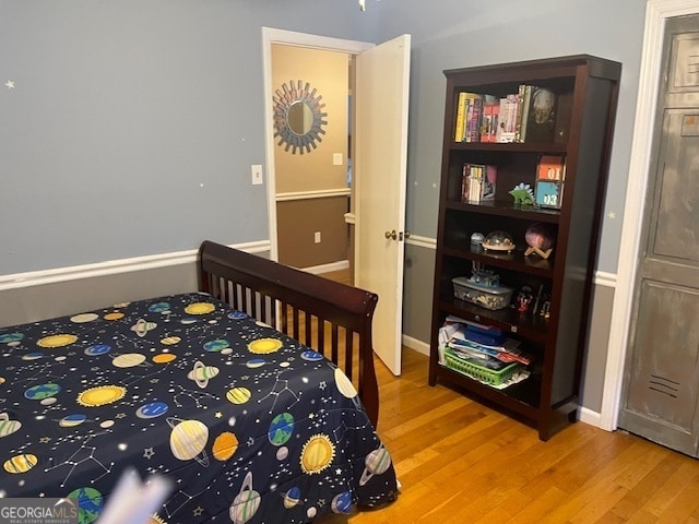 bedroom with wood-type flooring