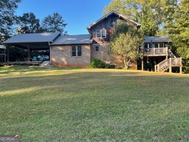 rear view of property featuring a yard and a deck