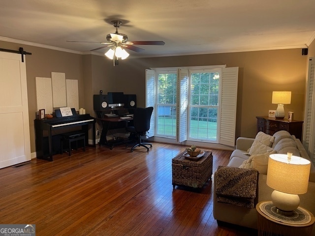 office space featuring ornamental molding, dark hardwood / wood-style floors, a barn door, and ceiling fan