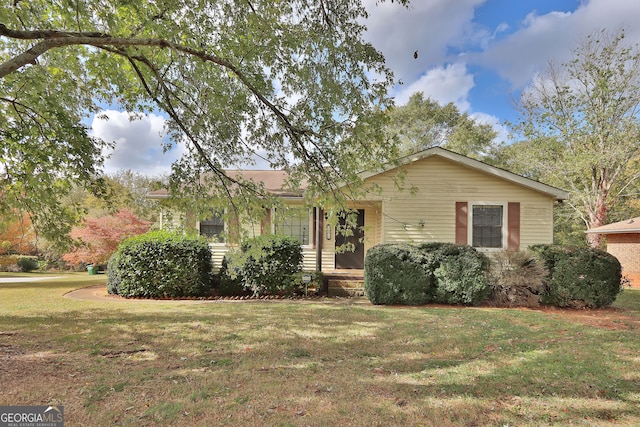 ranch-style home with a front lawn