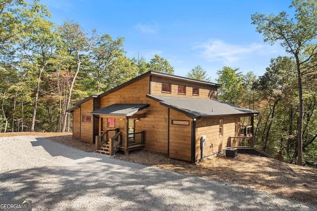 exterior space featuring covered porch and central AC