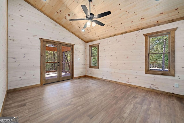 spare room with wood walls, wooden ceiling, and wood-type flooring