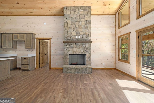 unfurnished living room featuring hardwood / wood-style floors, wood ceiling, and wood walls