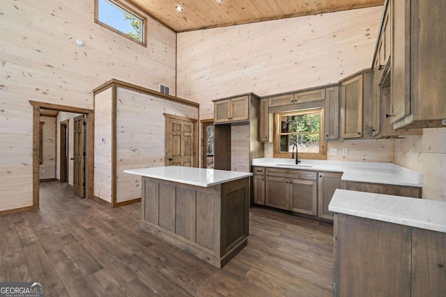 kitchen featuring a center island, high vaulted ceiling, dark wood-type flooring, and wood ceiling