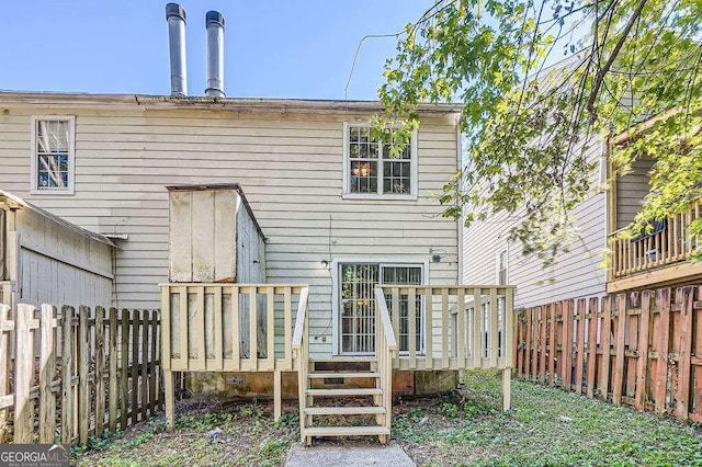 back of property with a wooden deck