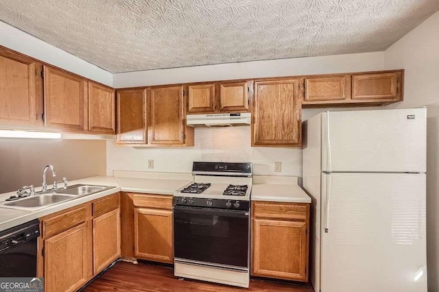 kitchen with black dishwasher, sink, white fridge, gas range, and dark hardwood / wood-style floors