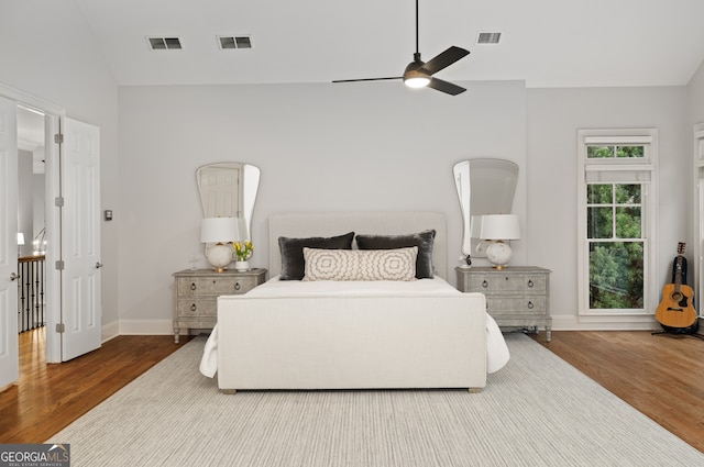 bedroom featuring ceiling fan, wood-type flooring, and vaulted ceiling