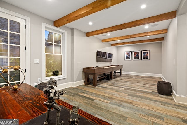 interior space with beamed ceiling and hardwood / wood-style floors