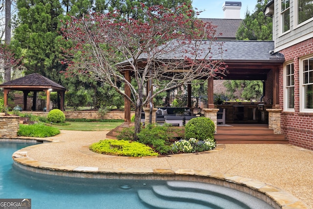 view of pool with a hot tub, a gazebo, an outdoor living space, and a patio area